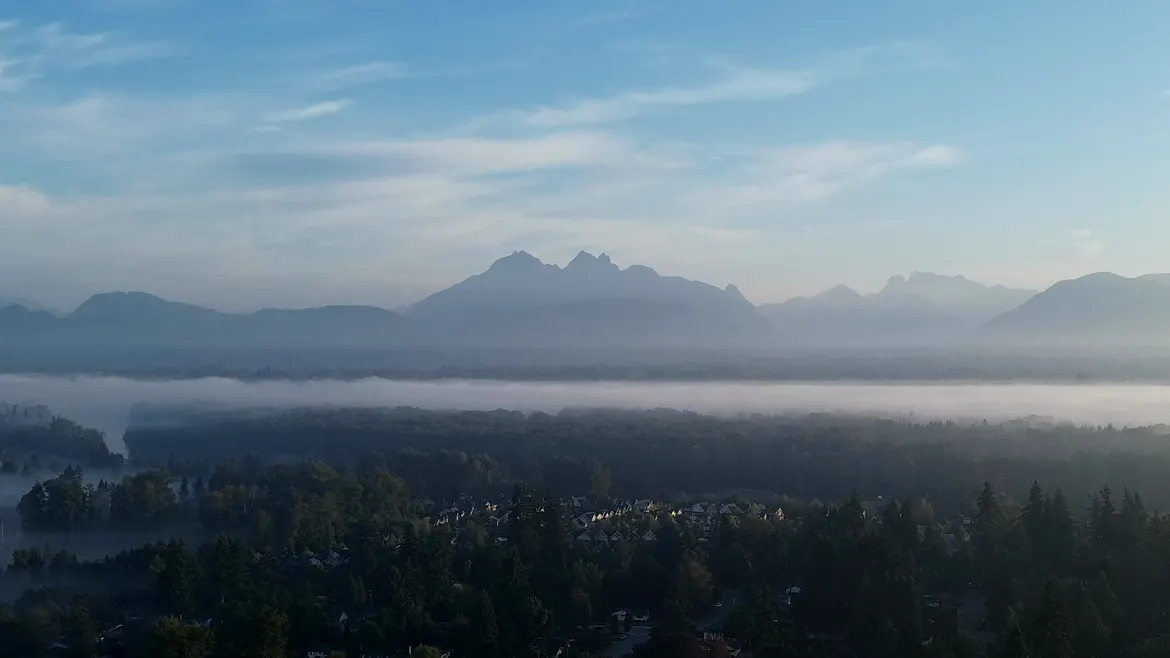 Golden Ears at sunrise above fog on the Fraser River, seen from Fort Langley