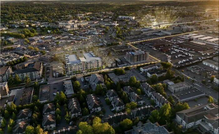 Aerial rendering looking over Downtown Langley at dusk, with Elijah’s six-storey massing shown among the surrounding low-rise blocks and townhome roofs