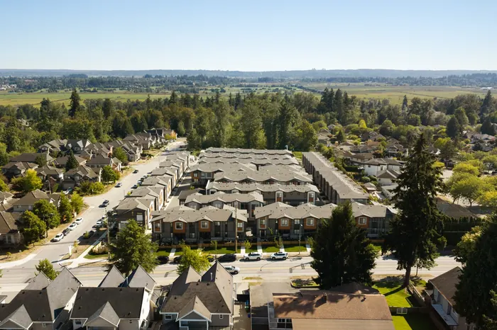 Aerial photograph of the Elwynn Green townhome community among the surrounding Fleetwood streets, with farmland and mountains on the horizon