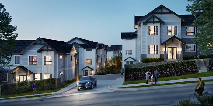 Artist’s rendering of Onyx & Ivory townhomes at dusk, with white gabled facades, lit windows and a car on the street in front