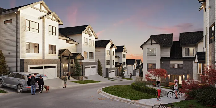 Artist’s rendering of an Onyx & Ivory street at sunset, with townhome fronts, garages and people walking